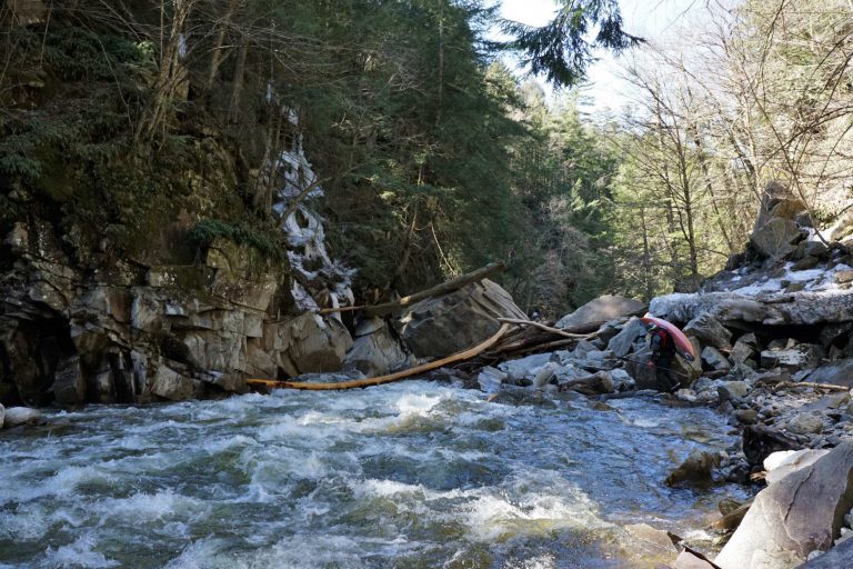 Mike Mainer portages a log on Tester rapid Middlebury River Vermont Whitewater Kayaking