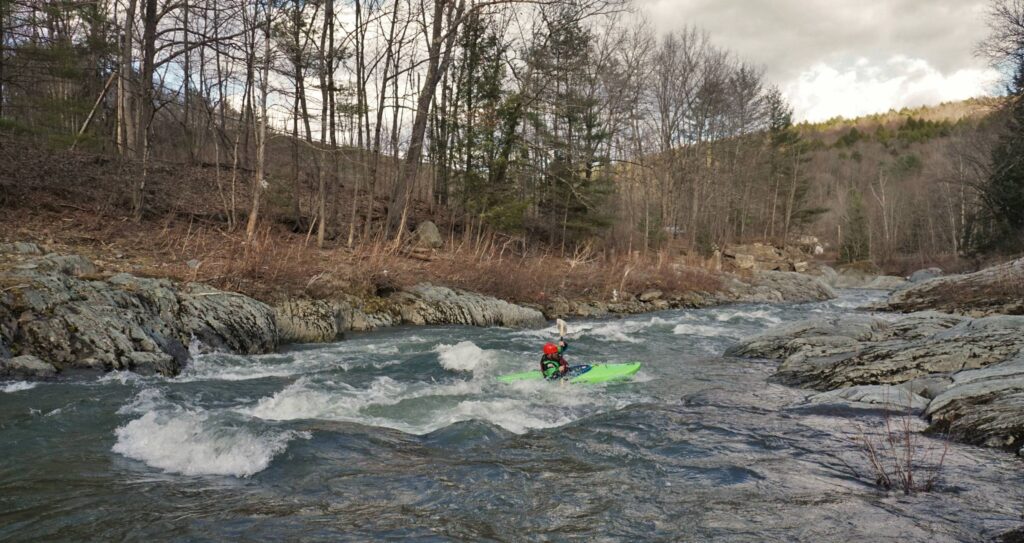 Adam Carparelli eddies out on the first rapid of the Mad River Vermont Whitewater Kayaking