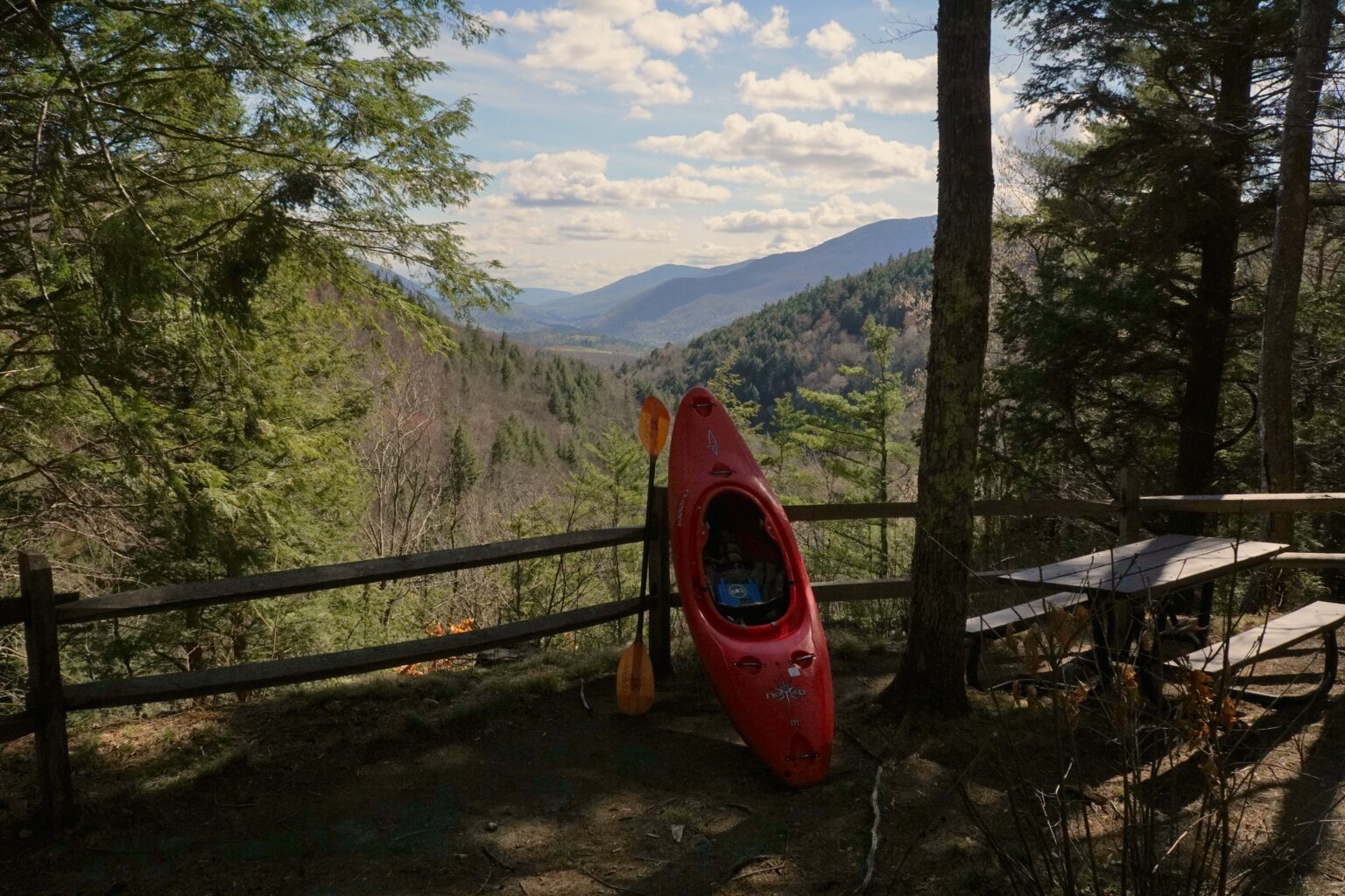 Kayak resting against a split rail fence at the Big Branch overlook Vermont