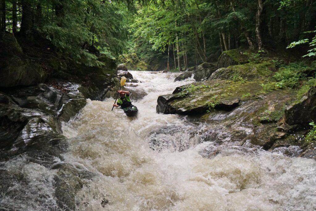 Justin Beckwith navigates the first rapid of the Top Mad River in his kayak. Vermont whitewater kayaking