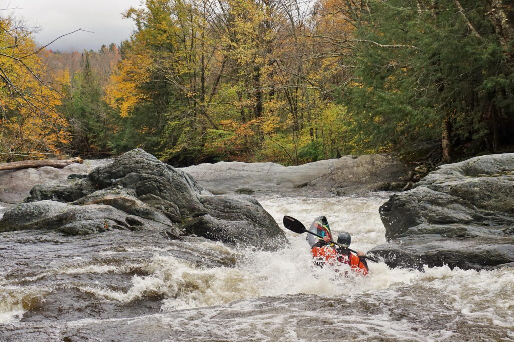 Kayaker Mike Mainer descends a drop on the Upper New Haven River in South Lincoln Vermont Whitewater Kayaking